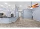 Open layout connecting kitchen to living room with tile flooring, and access to the main entry at 8836 Alafia Cove Dr, Riverview, FL 33569