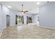 Spacious living room with tile floors, a ceiling fan, and natural light from sliding glass doors and windows at 8836 Alafia Cove Dr, Riverview, FL 33569