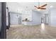 Open-concept living space with tile flooring, connecting to the kitchen with white cabinetry at 8836 Alafia Cove Dr, Riverview, FL 33569