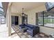 Covered patio with comfortable seating, ceiling fan, and mounted television at 8836 Alafia Cove Dr, Riverview, FL 33569