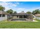 Backyard view of a private screened-in pool with deck and well-maintained lawn at 8836 Alafia Cove Dr, Riverview, FL 33569