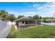 Backyard showcasing a screened-in pool, lawn, and privacy fence at 8836 Alafia Cove Dr, Riverview, FL 33569