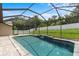 Long shot of the screened-in pool with waterfall feature at 8836 Alafia Cove Dr, Riverview, FL 33569