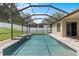 Screened-in pool with pristine water and waterfall feature at 8836 Alafia Cove Dr, Riverview, FL 33569