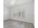 Clean bedroom with new floors, large window, and white walls at 900 Cove Cay Dr # 1B, Clearwater, FL 33760
