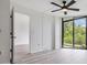 Bright bedroom with neutral paint, ceiling fan and view of the outdoor greenery at 900 Cove Cay Dr # 1B, Clearwater, FL 33760