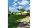 Well-manicured lawn area with palm trees and a walking path at 900 Cove Cay Dr # 1B, Clearwater, FL 33760