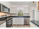 Updated kitchen featuring stainless steel appliances, wood look flooring, and natural lighting at 900 Cove Cay Dr # 1B, Clearwater, FL 33760