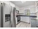 Charming kitchen featuring stainless steel refrigerator and appliances, and wood look flooring at 900 Cove Cay Dr # 1B, Clearwater, FL 33760