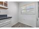 Bright laundry room featuring wood look flooring and plenty of natural light at 900 Cove Cay Dr # 1B, Clearwater, FL 33760
