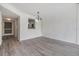 Open living room featuring neutral paint, light gray flooring and passthrough to kitchen and entry door at 900 Cove Cay Dr # 1B, Clearwater, FL 33760