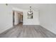 Bright living room featuring modern light fixture, light gray flooring, and neutral paint at 900 Cove Cay Dr # 1B, Clearwater, FL 33760