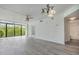 Spacious living room with views of the greenery outside and modern gray flooring at 900 Cove Cay Dr # 1B, Clearwater, FL 33760