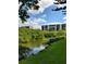 Scenic building view from the lush grounds, featuring a waterway and building backdrop at 900 Cove Cay Dr # 1B, Clearwater, FL 33760
