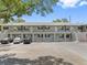 Two-story condominium building featuring individual balconies and ample parking at 101 Lake Ne Ave # 121, Largo, FL 33771