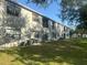View of a building with multiple AC units on a grassy area at 101 Lake Ne Ave # 121, Largo, FL 33771