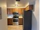 Functional kitchen featuring stainless steel appliances and wooden cabinets at 101 Lake Ne Ave # 121, Largo, FL 33771