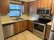 Bright kitchen featuring stainless steel appliances and tile flooring at 101 Lake Ne Ave # 121, Largo, FL 33771