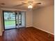 Cozy living room with ceiling fan and sliding glass door to balcony at 101 Lake Ne Ave # 121, Largo, FL 33771