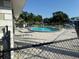 Community swimming pool with lounge chairs and patio area at 101 Lake Ne Ave # 121, Largo, FL 33771