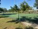 Outdoor community tennis court surrounded by lush greenery at 101 Lake Ne Ave # 121, Largo, FL 33771