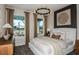 Bright bedroom with large windows offering scenic views and complemented by modern decor at 10305 Cross River Trl, Parrish, FL 34219