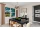 Elegant dining room featuring modern lighting fixtures, neutral colors, and an expansive backyard view at 10305 Cross River Trl, Parrish, FL 34219