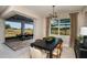 Dining room with modern chandelier, large windows, and patio access, blending indoor/outdoor living at 10305 Cross River Trl, Parrish, FL 34219