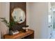 Welcoming entryway with a stylish mirror, wooden console table, and tasteful decor at 10305 Cross River Trl, Parrish, FL 34219