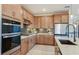 Bright kitchen with stainless steel appliances, tiled backsplash, and ample cabinet space at 10305 Cross River Trl, Parrish, FL 34219