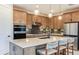 Modern kitchen featuring sleek cabinets, stainless steel appliances, and a spacious island with seating at 10305 Cross River Trl, Parrish, FL 34219