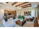 Inviting living room showcasing exposed beams, an open floor plan, and seamless kitchen integration at 10305 Cross River Trl, Parrish, FL 34219