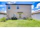 Spacious backyard with lush green grass, grill, and privacy fence, perfect for outdoor gatherings at 10360 Blue Plume Ct, Riverview, FL 33578