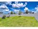 Large, well-maintained backyard enclosed by a privacy fence, ideal for outdoor activities and entertaining at 10360 Blue Plume Ct, Riverview, FL 33578