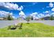 Expansive backyard features a privacy fence, lush lawn, and a cozy fire pit area for relaxation at 10360 Blue Plume Ct, Riverview, FL 33578