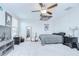 Eclectic bedroom with unique decor, ceiling fan, and a comfortable bed at 10360 Blue Plume Ct, Riverview, FL 33578
