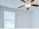 Close-up of a ceiling fan and blinds in a brightly lit bedroom at 10360 Blue Plume Ct, Riverview, FL 33578