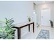 Entryway with tile flooring, console table, and a white front door at 10360 Blue Plume Ct, Riverview, FL 33578