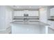 Kitchen featuring white cabinets, stainless steel appliances, and a granite island at 10360 Blue Plume Ct, Riverview, FL 33578