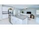Kitchen island boasts granite countertops and stainless steel dishwasher open to the living room at 10360 Blue Plume Ct, Riverview, FL 33578
