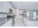 Bright kitchen features granite countertops, stainless steel appliances, and white cabinetry at 10360 Blue Plume Ct, Riverview, FL 33578