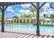 Inviting community pool with clear blue water, surrounded by lounge chairs and swaying palm trees at 10360 Blue Plume Ct, Riverview, FL 33578