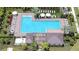 Overhead view of a pristine community pool area with ample lounge chairs and well-manicured landscaping at 10360 Blue Plume Ct, Riverview, FL 33578