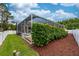 Charming backyard view with a well-maintained lawn, privacy fence, and a screened-in patio at 10532 Plantation Bay Dr, Tampa, FL 33647