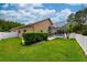 Charming backyard view with a well-maintained lawn, privacy fence, and a screened-in patio at 10532 Plantation Bay Dr, Tampa, FL 33647