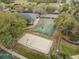 Aerial view shows the community basketball court, volleyball court, and recreation center at 10532 Plantation Bay Dr, Tampa, FL 33647