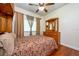 Bedroom with dark wood flooring, ceiling fan, and a built-in headboard with storage at 10532 Plantation Bay Dr, Tampa, FL 33647