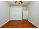 Bedroom featuring wood floor, ceiling fan, closet, and interior door at 10532 Plantation Bay Dr, Tampa, FL 33647