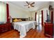 Bright bedroom featuring two queen beds, hardwood floors, ceiling fan, and a sliding glass door to the pool at 10532 Plantation Bay Dr, Tampa, FL 33647