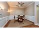 Dining room with seating for four, hardwood floors and decorative wainscotting at 10532 Plantation Bay Dr, Tampa, FL 33647